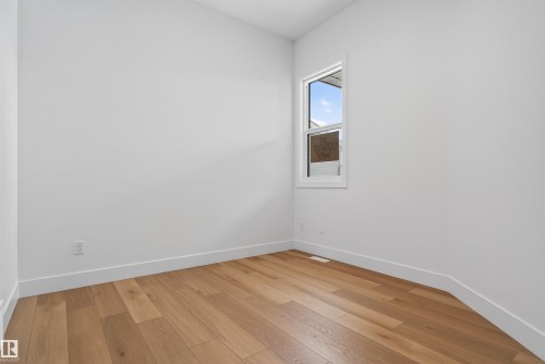 This room features light-colored hardwood flooring and a window providing natural light - 27 Rosewood Way, St. Albert, AB - Indoor Photo Showing Other Room