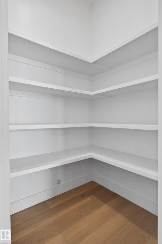 Corner shelving unit with white finishes and light wood flooring - 27 Rosewood Way, St. Albert, AB - Indoor With Storage