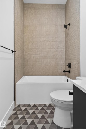 This bathroom features a white bathtub, a toilet, and a vanity with a white countertop - 27 Rosewood Way, St. Albert, AB - Indoor Photo Showing Bathroom