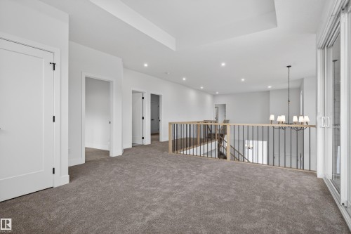 Spacious open loft area with plush gray carpeting - 27 Redpoll Wynd, St. Albert, AB - Indoor Photo Showing Other Room