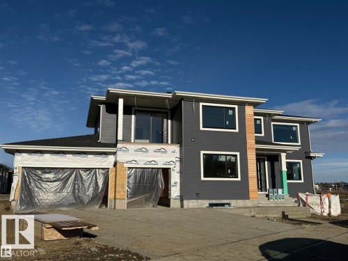 Rear view of property featuring concrete driveway - 27 Redpoll Wynd, St. Albert, AB - Outdoor