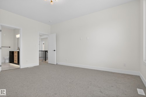 Unfurnished bedroom with light carpet and connected bathroom - 19 Rosa Crescent, St. Albert, AB - Indoor Photo Showing Other Room