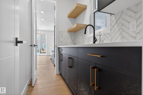 Bar area with open shelves, light wood-style floors, and a chandelier - 19 Rosa Crescent, St. Albert, AB - Indoor Photo Showing Other Room
