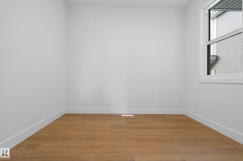 Spare room with light wood-style floors and baseboards - 19 Rosa Crescent, St. Albert, AB - Indoor Photo Showing Other Room