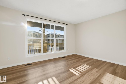 Living room with new light wood laminate flooring - 3014 31 Avenue, Edmonton, AB - Indoor Photo Showing Other Room
