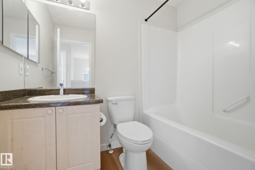 Full bath with vanity, bathtub / shower combination, and dark wood-style flooring - 3014 31 Avenue, Edmonton, AB - Indoor Photo Showing Bathroom