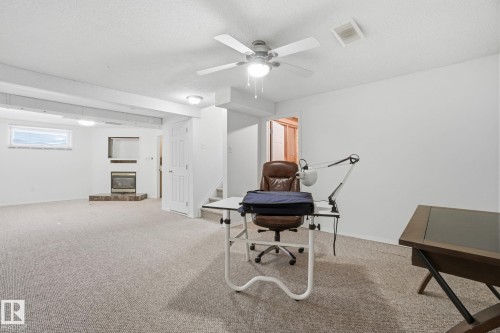 Basement with a glass covered fireplace and light carpet - 3014 31 Avenue, Edmonton, AB - Indoor
