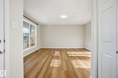 Unfurnished room featuring wood finished floors and a textured ceiling - 3014 31 Avenue, Edmonton, AB - Indoor Photo Showing Other Room