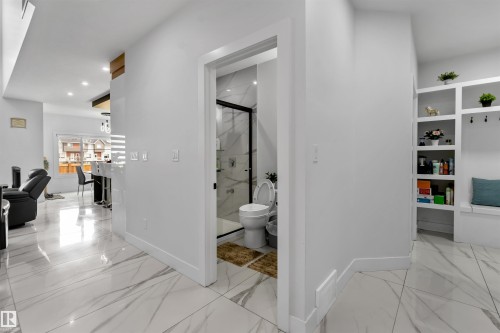 Hallway featuring light marble finish floors and recessed lighting - 15518 13A Avenue, Edmonton, AB - Indoor Photo Showing Other Room
