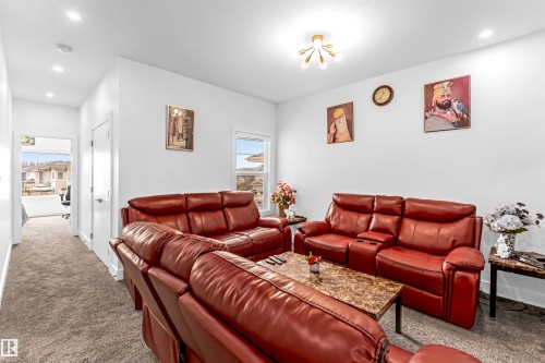 Carpeted living area with recessed lighting and baseboards - 15518 13A Avenue, Edmonton, AB - Indoor Photo Showing Living Room