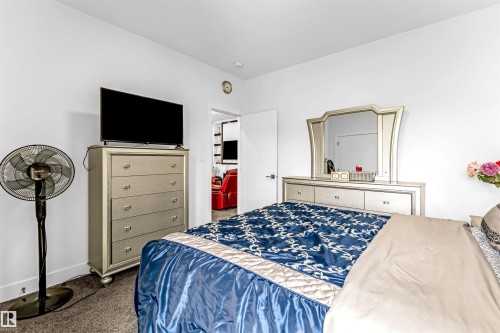 Bedroom with dark carpet and baseboards - 15518 13A Avenue, Edmonton, AB - Indoor Photo Showing Bedroom