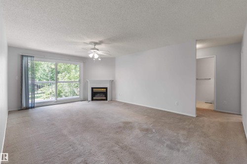 304 8811 106A Avenue, Edmonton, AB - Indoor Photo Showing Living Room With Fireplace