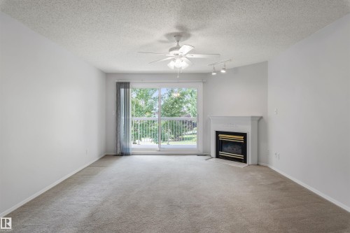 304 8811 106A Avenue, Edmonton, AB - Indoor Photo Showing Living Room With Fireplace