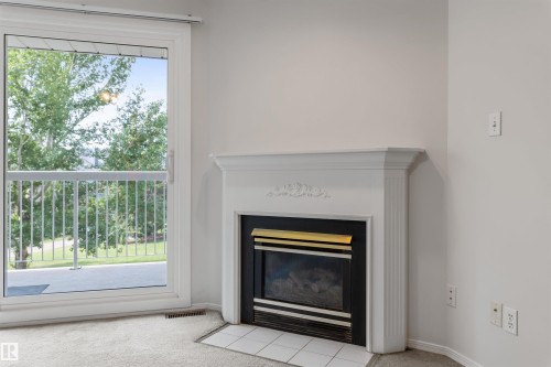 304 8811 106A Avenue, Edmonton, AB - Indoor Photo Showing Living Room With Fireplace