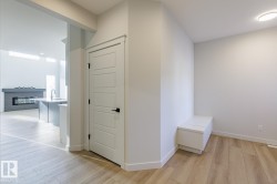Hall with light wood-style flooring and baseboards - 