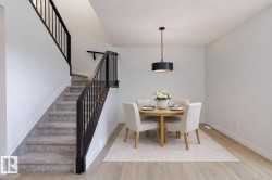 Dining room with stairway and light wood-style floors - 