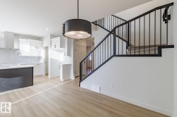 Unfurnished living room with stairs and light wood-style floors - 