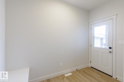 Entryway featuring baseboards and wood finished floors - 