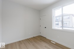 Empty room featuring baseboards and light wood finished floors - 