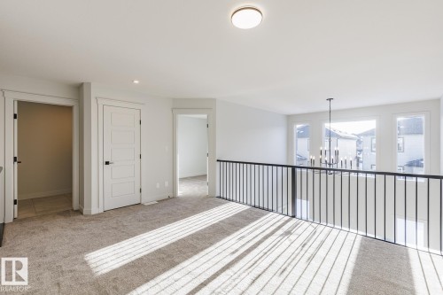 Carpeted spare room with a chandelier and recessed lighting - 3719 42 Avenue, Beaumont, AB - Indoor Photo Showing Other Room