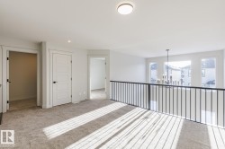 Carpeted spare room with a chandelier and recessed lighting - 