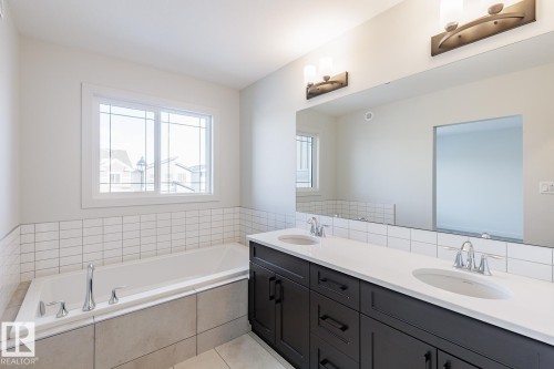 Full bathroom with double vanity and a garden tub - 3719 42 Avenue, Beaumont, AB - Indoor Photo Showing Bathroom