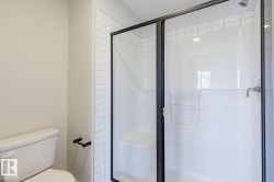 Bathroom with a stall shower and toilet - 