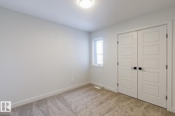 Unfurnished bedroom with light colored carpet and a closet - 