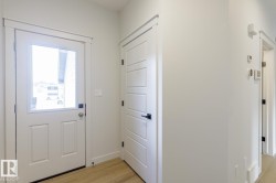 Doorway to outside with wood finished floors and baseboards - 