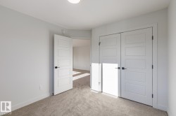 Unfurnished bedroom featuring light carpet and a closet - 