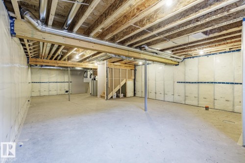 Unfinished basement featuring water heater - 3719 42 Avenue, Beaumont, AB - Indoor Photo Showing Basement