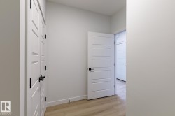 Corridor featuring light wood-style floors and baseboards - 