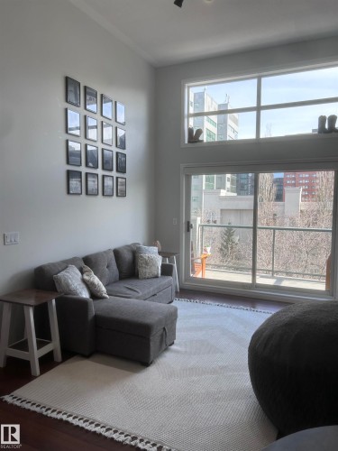 Living area featuring wood finished floors - 506 10046 110 Street, Edmonton, AB - Indoor Photo Showing Living Room