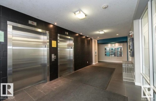 Building lobby featuring a textured ceiling - 105 2584 Anderson Way, Edmonton, AB - Indoor Photo Showing Other Room