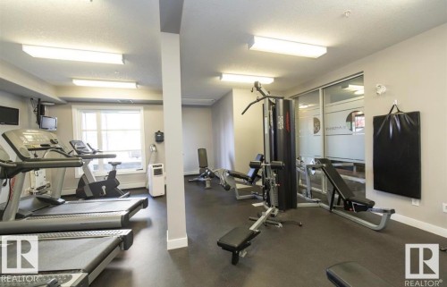 Exercise room featuring a textured ceiling - 105 2584 Anderson Way, Edmonton, AB - Indoor Photo Showing Gym Room