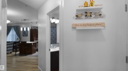 Hallway featuring a textured ceiling and light wood finished floors - 