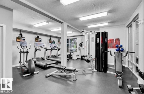 Workout area featuring a textured ceiling - 105 2584 Anderson Way, Edmonton, AB - Indoor Photo Showing Gym Room