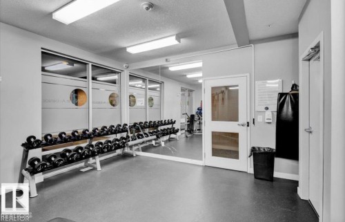 Exercise room featuring a textured ceiling - 105 2584 Anderson Way, Edmonton, AB - Indoor Photo Showing Gym Room