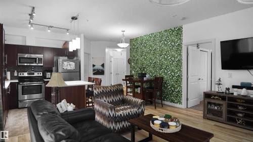Living area with light wood-style flooring and baseboards - 105 2584 Anderson Way, Edmonton, AB - Indoor