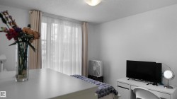 Bedroom with a textured ceiling and a desk - 