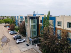 View of property featuring uncovered parking - 