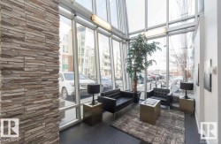 Building lobby with floor to ceiling windows and a towering ceiling - 