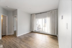 Unfurnished room with light wood finished floors and a baseboard radiator - 