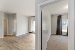 Unfurnished room with light wood-style flooring and light colored carpet - 