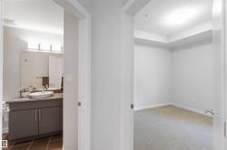 Bathroom with vanity and dark colored carpet - 