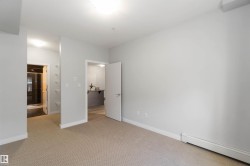 Unfurnished bedroom with a baseboard radiator and carpet - 