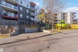 View of apartment building / complex featuring a garage - 