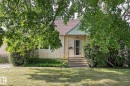 View of front of home with stucco siding, a front yard, and roof with shingles - 11559 80 Avenue, Edmonton, AB  - Outdoor 