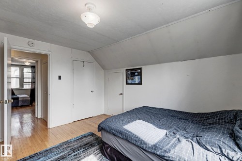 Bedroom featuring lofted ceiling, wood finished floors, and a closet - 11559 80 Avenue, Edmonton, AB - Indoor Photo Showing Bedroom