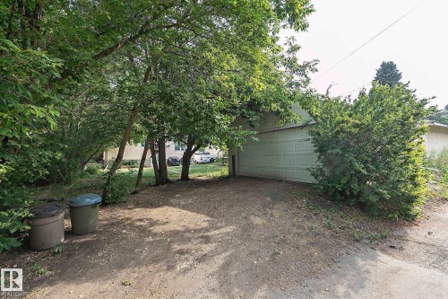 View of yard featuring a garage and an outdoor structure - 11559 80 Avenue, Edmonton, AB - Outdoor